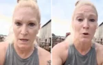 MAGA dairy farm owner speaks with a concerned expression in front of barns.
